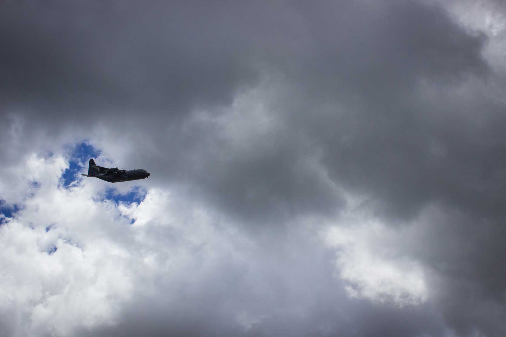 An airplane flying in a cloudy sky