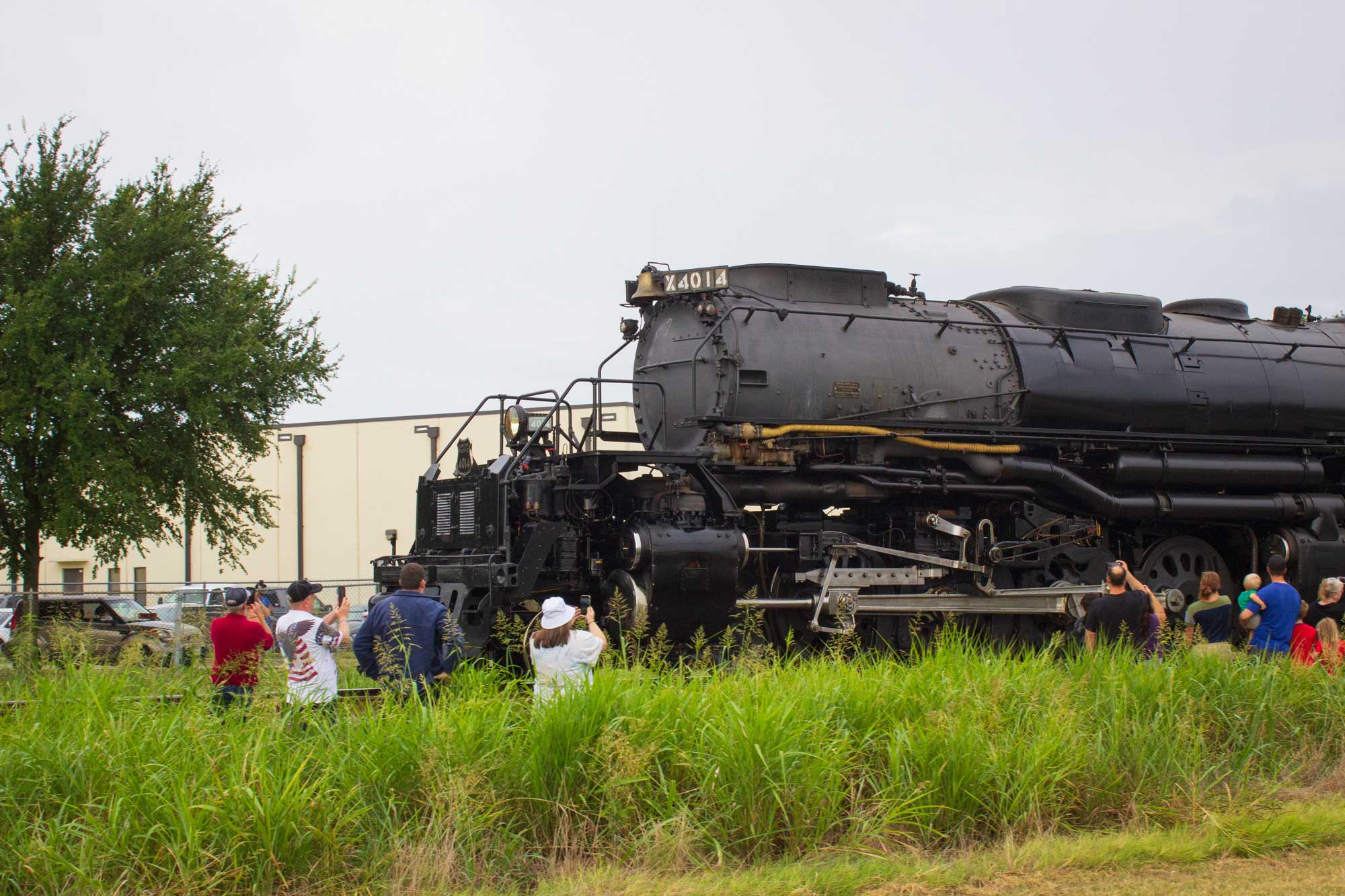 The Big Boy steam locomotive rolling passed people standing in a field