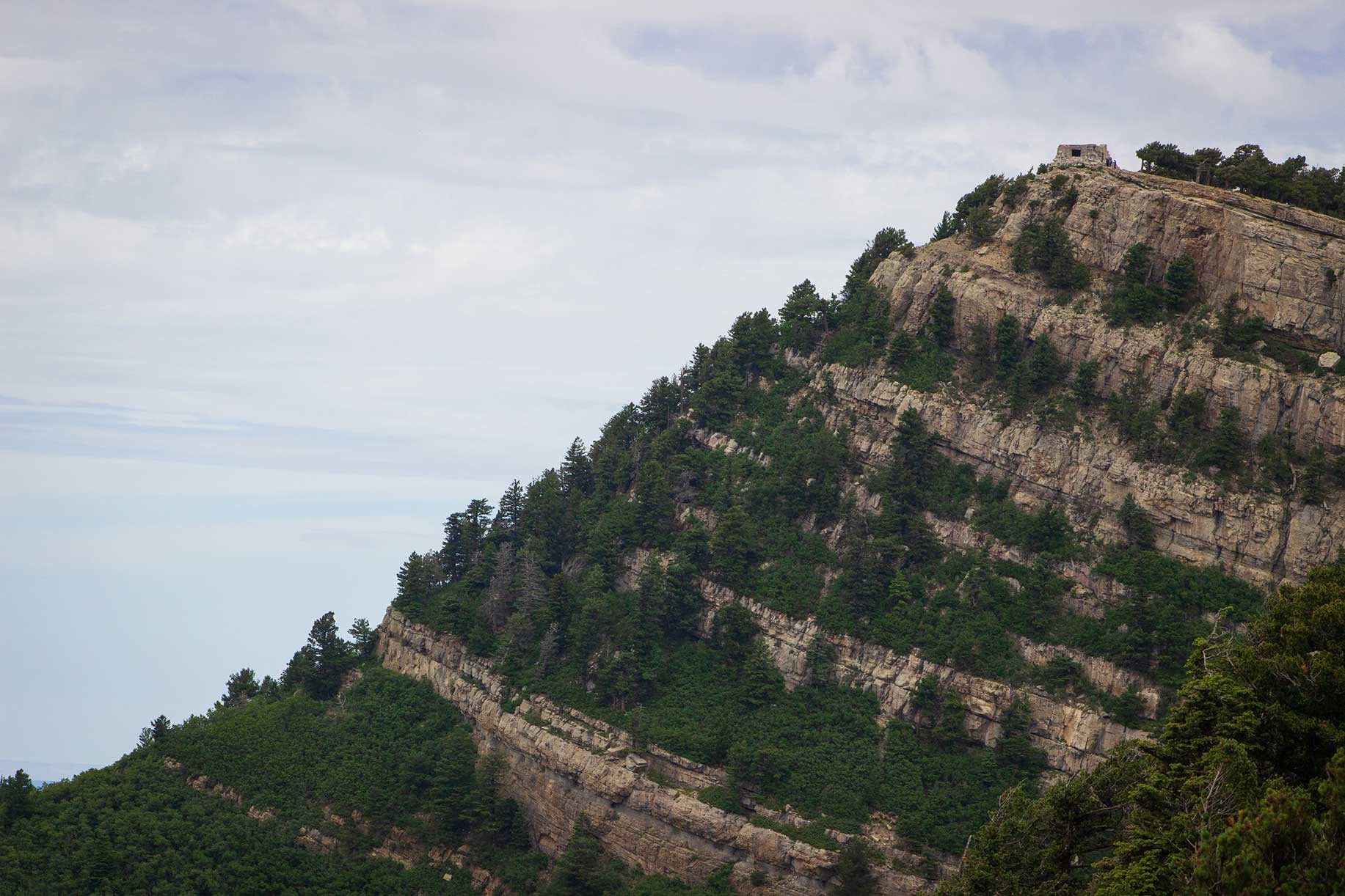 A stone building sitting at the top of a mountain