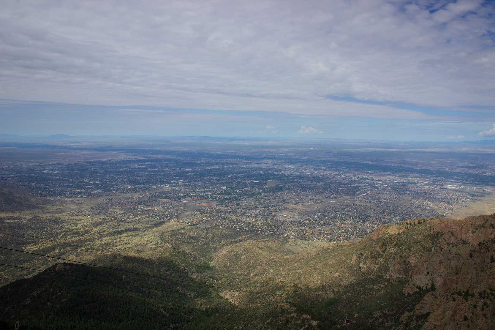 A city sits beneath a tall mountain