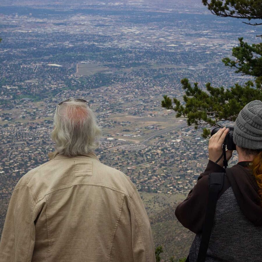 Two men looking out over a mountain
