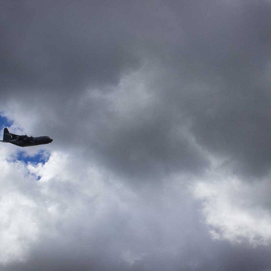 An airplane flying in a cloudy sky