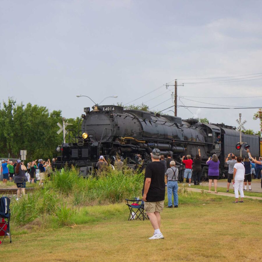 The Big Boy steam locomotive rolling passed people standing in a field